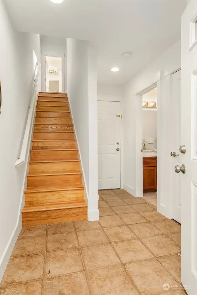 Enter into your recently updated and well maintained home. This hallway takes you upstairs, or to the garage or to the bedroom and full bath on this level.  You also have access to the back yard that is private and fully fenced. Pets anyone?