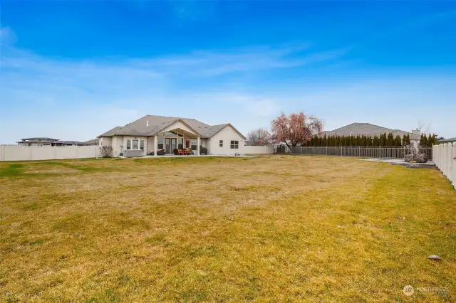 The fully fenced backyard has a covered patio and plenty of room for pets, playing, gardening, or adding a pool, if desired.