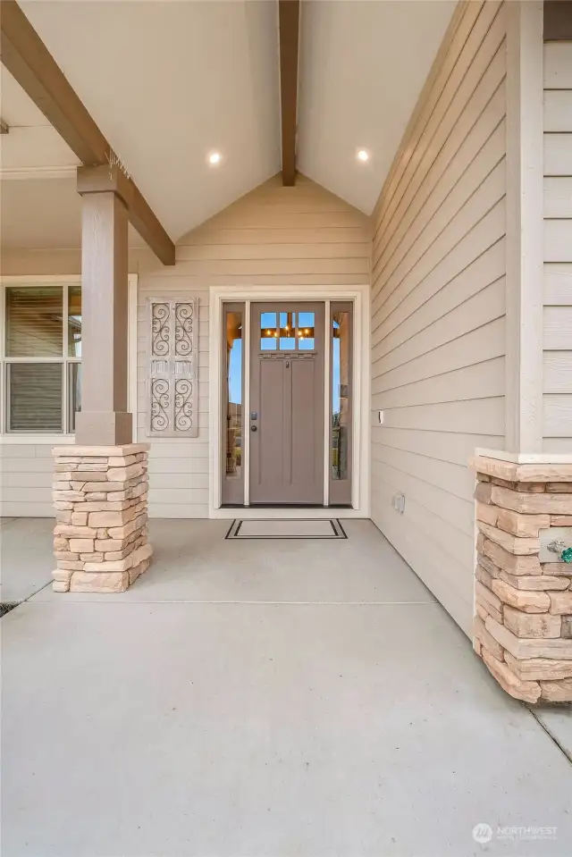 Covered front entry provides protection from the elements as you welcome guests.