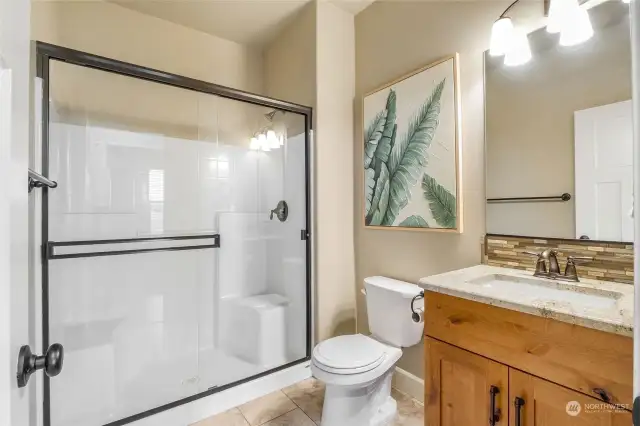 Roomy bathroom with shower is conveniently located near the front bedroom.