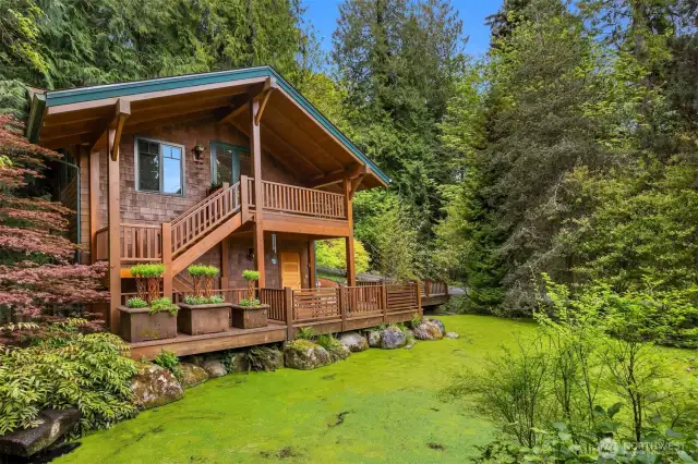 Carriage house with pond and water feature.  Enjoy the covered porch while you watch for the mallard ducks or be serenaded by the chorus of frogs.