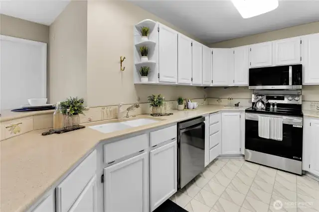 The kitchen has plenty of cupboard and counter space to suit your needs