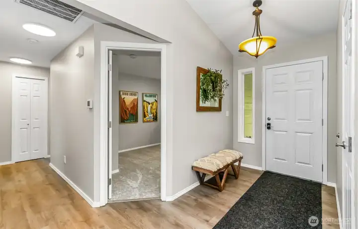 View of front door, entry hallway and door to office or bedroom