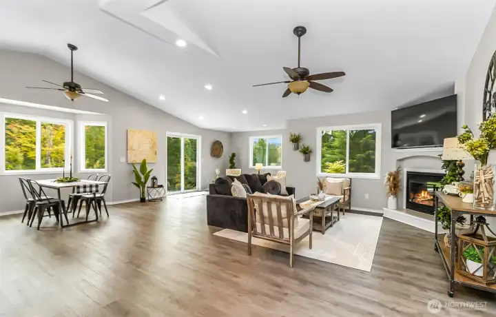 Walking into the open concept living room with fireplace. Home comes with the TV