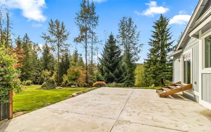 Back patio ready for a big hot tub, stairs coming out of the sitting room. This is your outdoor oasis