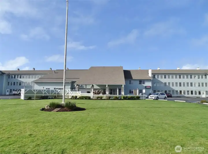 Front of the Canterbury Inn w/ a large lawn area.