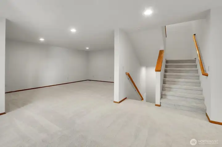 Staircase on the main level leads up to the 2nd floor and down to the garage.