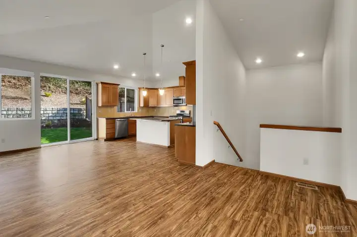 The open floor plan with vaulted ceilings creates a spacious atmosphere in the main living area on the upper level.