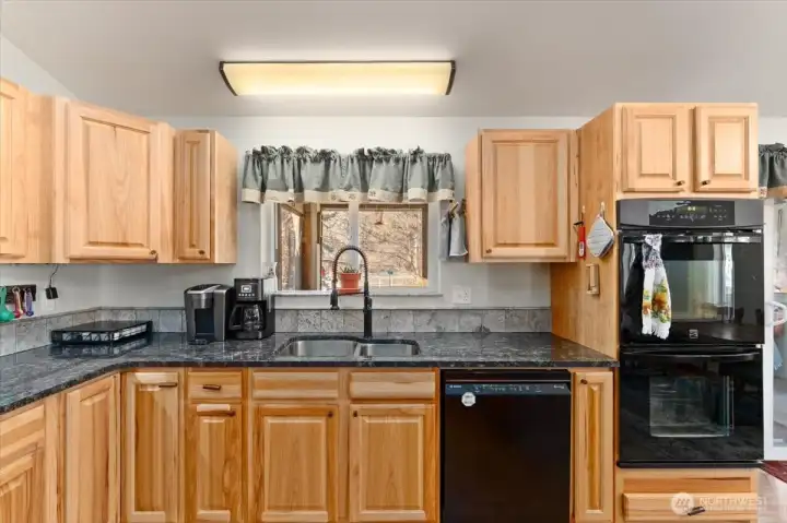 Double oven and hickory cabinets.