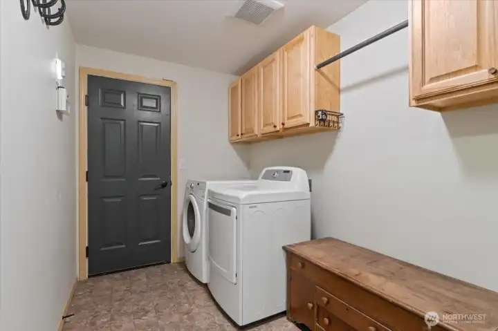 Large laundry room with space for extra refrigerator or freezer.