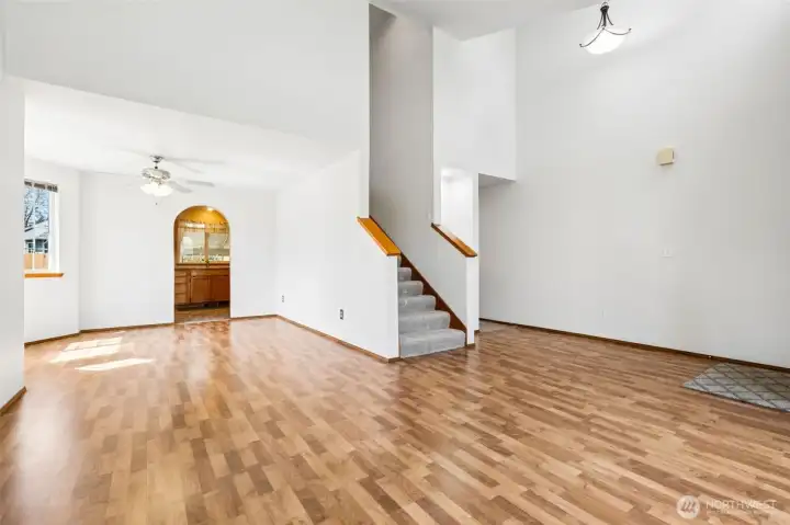 Big living room and dining room with laminte floors.