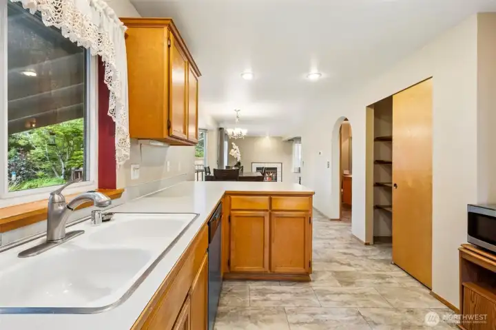 Kitchen with large pantry. Kitchen is open to the additional eating area and family room with gas fireplace.