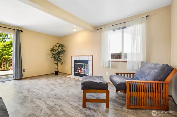 Family room with gas fireplace. Sliding door leads to deck, a large covered patio and a beautiful yard.