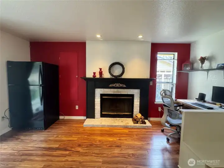 The family room with its wood burning stove, also has a Luxury Vinyl Planking floor. To your right is one of the seats of the dining nook.