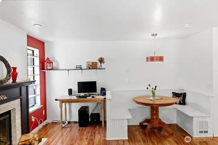 Gathering area off kitchen features a dining nook and room for a desk
