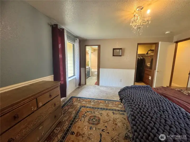 The primary bedroom with its own private walk-in closet and double vanity bathroom.