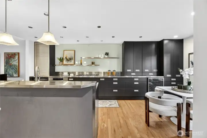 Updated kitchen with sleek cabinetry, large island & stainless steel chefs kitchen. Open layout, ample storage & modern finishes create a stylish, functional space.