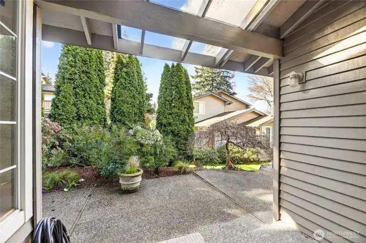 Spacious rear yard retreat just off the dining room, featuring a partially covered patio & lush, mature landscaping. Ideal for outdoor dining, relaxing or year-round enjoyment.