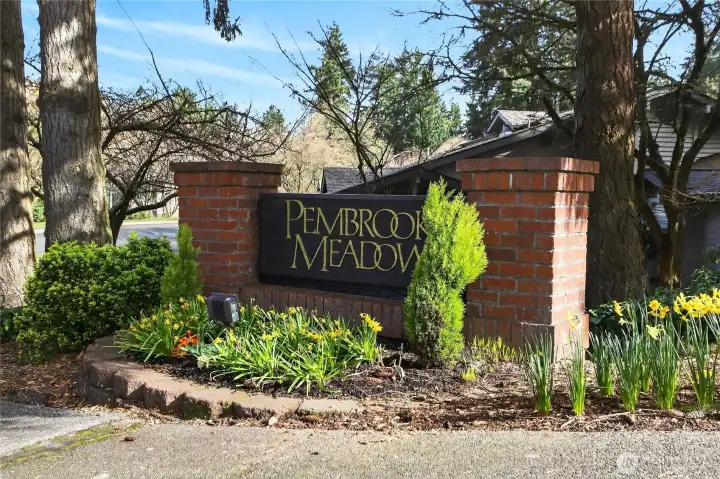Charming entry monument for Pembrook Meadows, beautifully landscaped with seasonal color & mature greenery—creating a warm, inviting first impression as you arrive into this sought-after community.