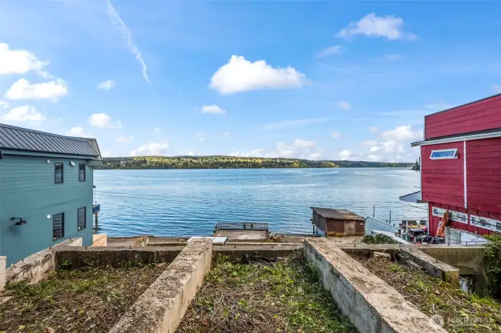Enjoy this view of Colvos Passage and Vashon Island.  In the evening you can see the city lights of Seattle! This is the foundation for the top floor on the lot.