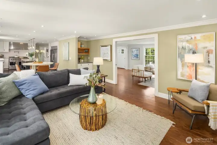 The main living areas connect seamlessly from kitchen to dining to family room to living room — an open, flowing layout that makes the whole main floor feel like one continuous space