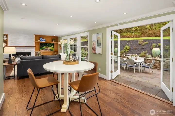 Open kitchen and casual dining with seamless flow to the family room and French doors to the patio — the layout daily life is built around