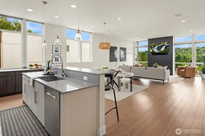 A true great room, this main living area features floor-to-ceiling windows and an abundance of natural light.
