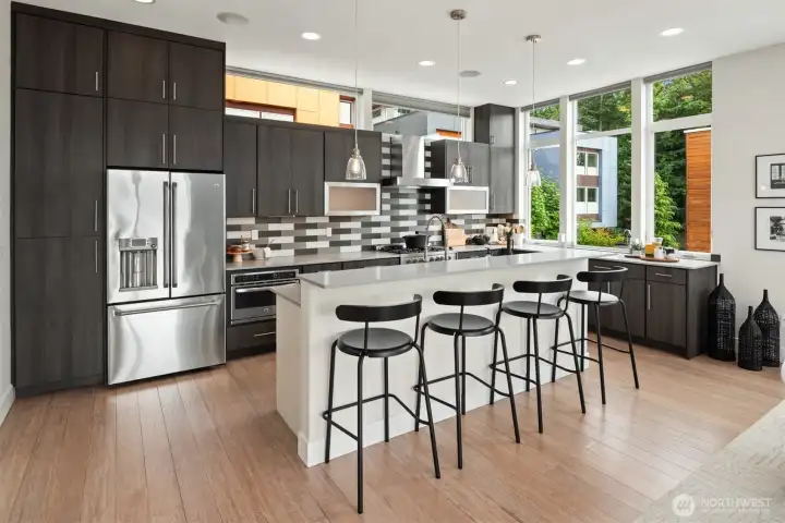 This thoughtfully designed kitchen looks as great as it functions with it's overhead windows and designer tiled backsplash.