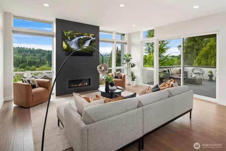 A gas fireplace with designer tile provides the stunning centerpiece to the floor-to-ceiling windows flanking it.