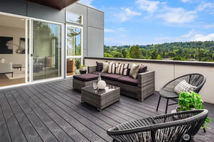 This spacious deck with composite decking is just off the main living room and den and with an extended soffit to keep you dry.
