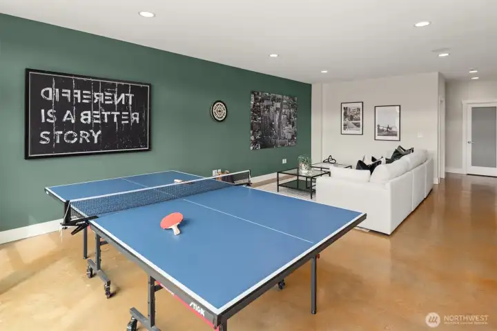 The rec room easily accommodates a full size ping pong table with plenty of room for the world's largest sectional sofa just beyond.