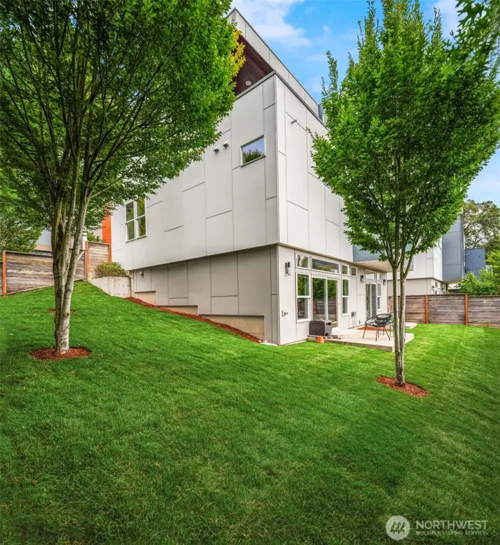 This picture shows off the wrap around yard and you can see the upper deck peeking out above the front corner.
