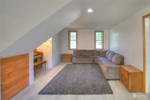 Downstairs family room is a conversion that has a piano/desk nook, plenty of seating area and would be great for a tv room or gaming area.