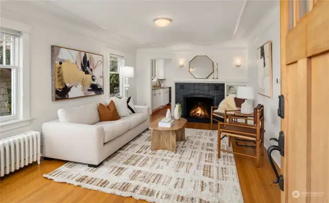 You are greeted by gorgeous hardwood floors running throughout the main level of the home, stunning molding, and an updated fireplace that has retained its old Seattle charm.