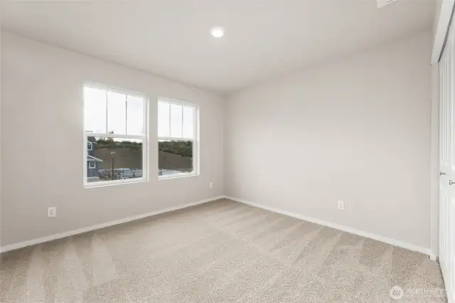 Guest Bedroom. Photos of previously built home of same floorplan. Colors, Specifications, and Options may vary on actual home.