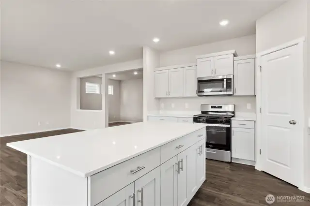 Kitchen and Living Room. Photos of previously built home of same floorplan. Colors, Specifications, and Options may vary on actual home.