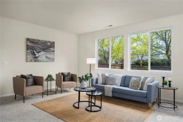 The living room is massive and is open to the large kitchen + dining room