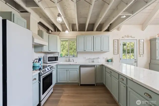 Beautifully redone kitchen with Samsung Cafe appliances, exposed beams,quartz countertops