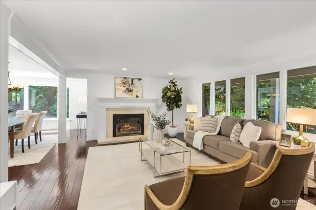 Formal living room with walls of windows and gas fireplace.