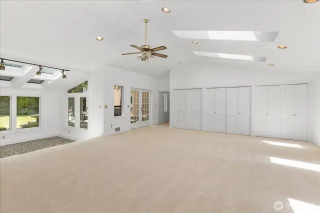 Rec room has skylights, a ceiling fan and a wood burning free standing stove.