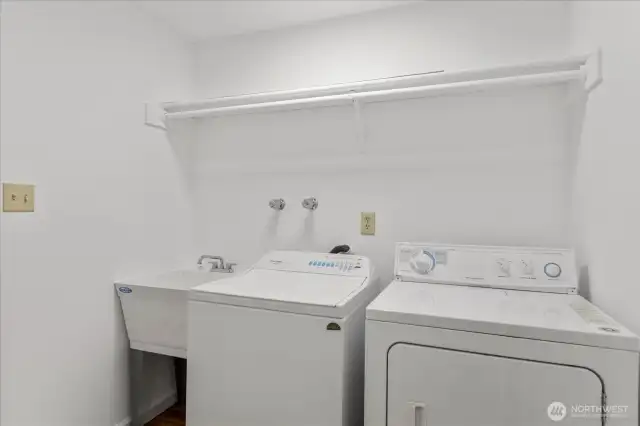 Laundry room located on first floor between the two main floor bedrooms.