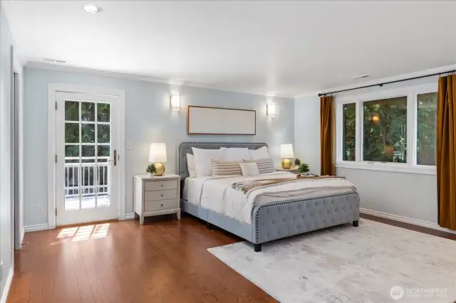 Generous primary suite with anderson windows and door out to private deck.