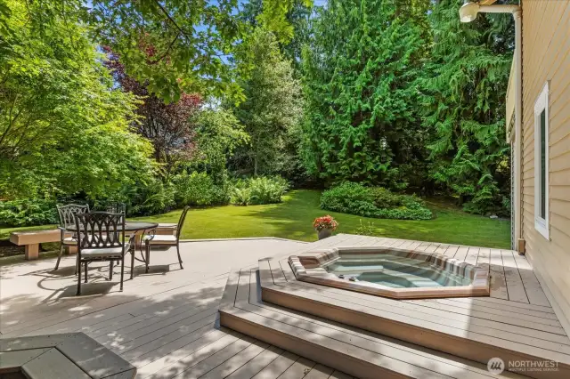 Outdoor entertainment space features oversized deck and hot tub to enjoy the serenity and privacy.
