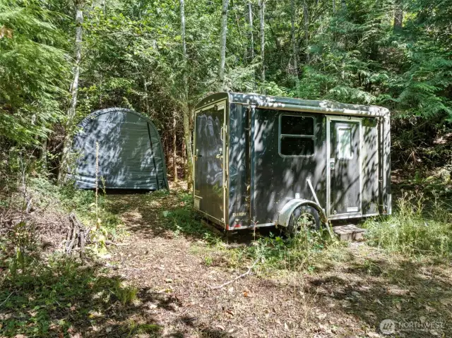 Property comes with a 12' utility trailer complete with queen bed, twin bunks, cubbies for storage, and awning. Appx 8x10 waterproof storage tent also included in sale.