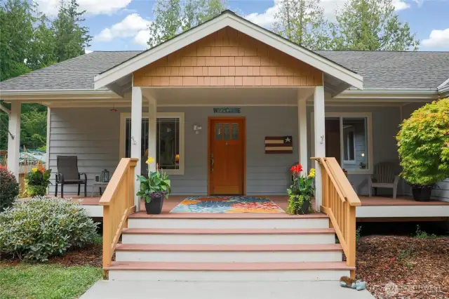 Covered entry with multiple seating areas is so inviting!