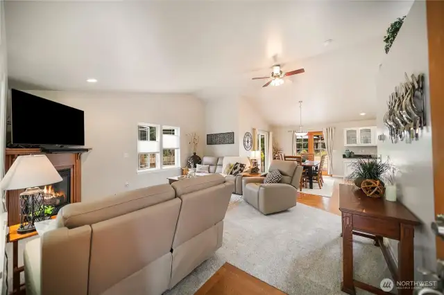 Upon entering, you are welcomed by soaring ceilings and an inviting living room with a propane fireplace.
