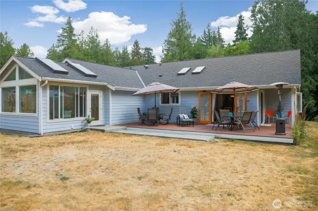 Spacious, low-maintenance deck with multiple seating areas and gas hookups, perfect for outdoor entertaining.