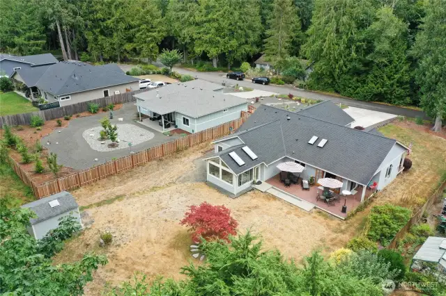 The backyard features a spacious shed for all your storage needs and room for a garden—what creative ideas will you bring to this versatile space?