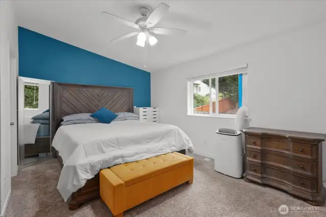 Primary suite with vaulted ceiling and fan, walk-in closet and secondary closet.