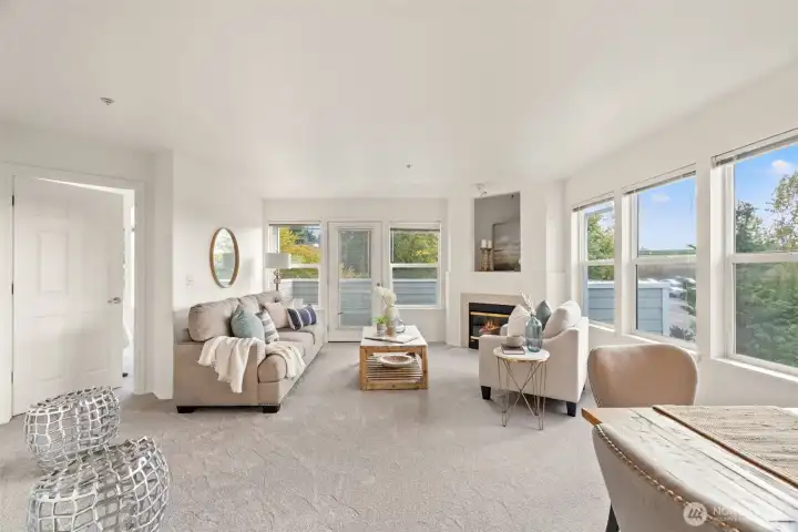 Open and bright living room with fireplace.